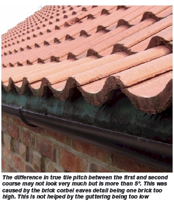 The difference in true tile pitch between the first and second course may not look very much but is more than 5. This was caused by the brick corbel eaves detail being one brick too high. This is not helped by the guttering being too low